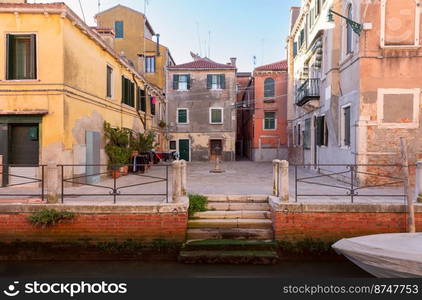 Traditional old colorful houses along the canal on a sunny day. Venice. Italy.. Traditional Venetian houses along the canal on a sunny day.