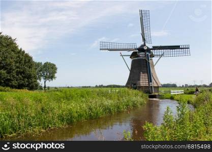 Traditional old dutch windmill in a summer landscape