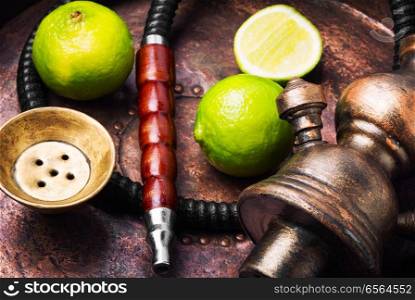 Traditional oriental smoking hookah with citrus lime flavor.Stylish lime shisha. Oriental hookah shisha with lime