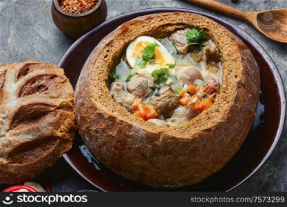 Traditional polish flour soup or zurek soup.Polish cuisine. Polish soup zurek in bread pot