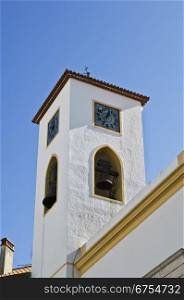 Traditional portuguese clock and bell tower in clear sky