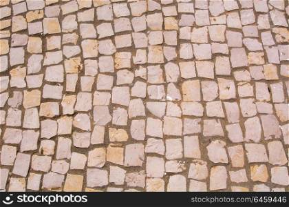 Traditional Portuguese stone sidewalk pavement texture pattern