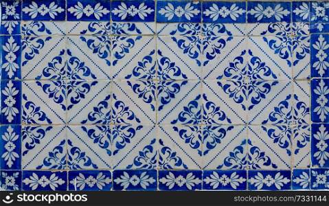 Traditional Portuguese tiles from a building in a street in Lisbon.