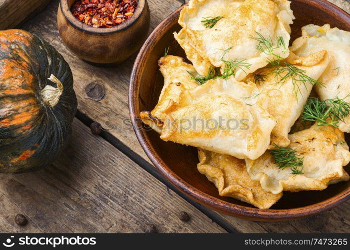 Traditional pumpkin dumplings or vareniki.Fried pumpkin vareniki.Autumn food. Homemade dumplings with pumpkin