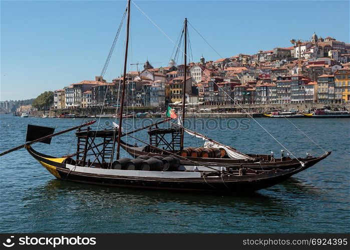 Traditional Rabelo Boat on the Bank of the River Douro and Colorful Facades of Typical Houses- Porto, Portugal