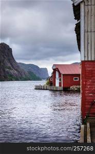 Traditional red houses in small historic fishing village Norway. Wooden houses in norwegian fishing village
