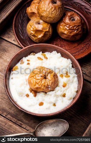 Traditional rice porridge on milk with apples. Rice porridge with apples