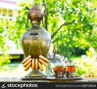 Traditional russian tea with samovar in the garden