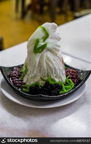 Traditional Singapore cold dessert called Chendol, served with coconut, jelly grass and red beans. Also commons in Malaysia Indonasia Thailand and Vietnam
