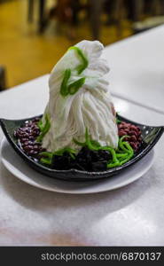 Traditional Singapore cold dessert called Chendol, served with coconut, jelly grass and red beans. Also commons in Malaysia Indonasia Thailand and Vietnam