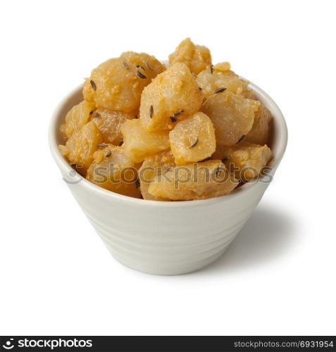 Traditional Slovak pieces of hand cheese with caraway seeds in a bowl on white background