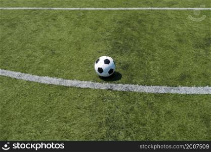 Traditional soccer ball on soccer field. A Traditional soccer ball on soccer field