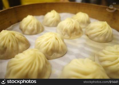 Traditional soup dumpling Xiao Long Bao is a popular Shanghai Chinese dim sum steamed in bamboo steamers.