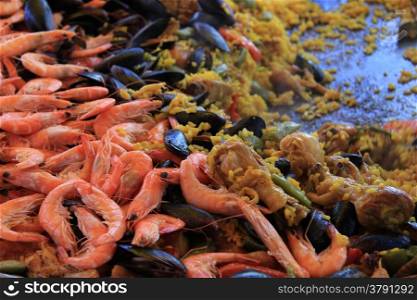 Traditional Spanish paella: saffron rice, chicken, meat and seafood