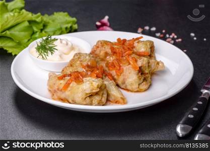 Traditional stuffed cabbage with minced meat and rice, served in a tomato sauce. Cabbage rolls stuffed with ground beef and rice served on a white plate