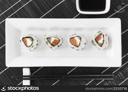 traditional tasty sushi white tray with sauce chopsticks