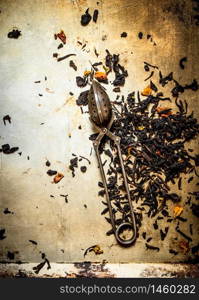 Traditional tea with infuser spoon. On rustic background.. Traditional tea with infuser spoon.