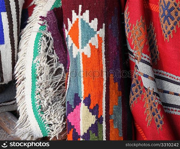 Traditional textiles on sale in Souq Waqif, Doha. The patterns reflect Islam&acute;s enthusiasm for geometric designs, as representation of the forms of living things is banned under a strict interpretation of Qur&acute;anic teaching. The colours were restricted by the available natural dyes.