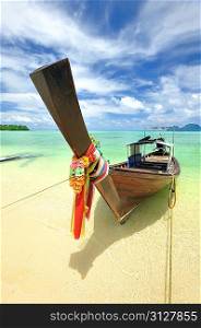Traditional Thai boat in beautiful beach landscape in Thailand