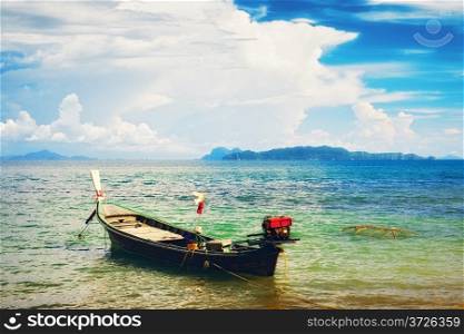 traditional thai long boat on beach in Thailand