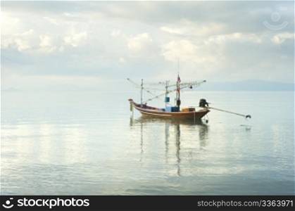 Traditional thailand boat in the sea at sunrise