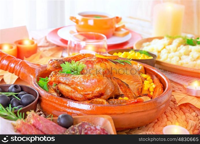 Traditional Thanksgiving family dinner with tasty grilled turkey in centerpiece of festive table, many delicious food for traditional autumn holiday