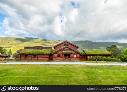 Traditional turf roof house with green hills in the foreground, Valle, Aust-Agder county, Norway