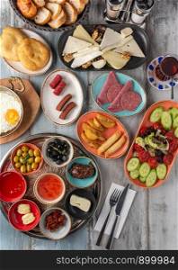 Traditional Turkish Breakfast served with traditional turkish tea on wooden table