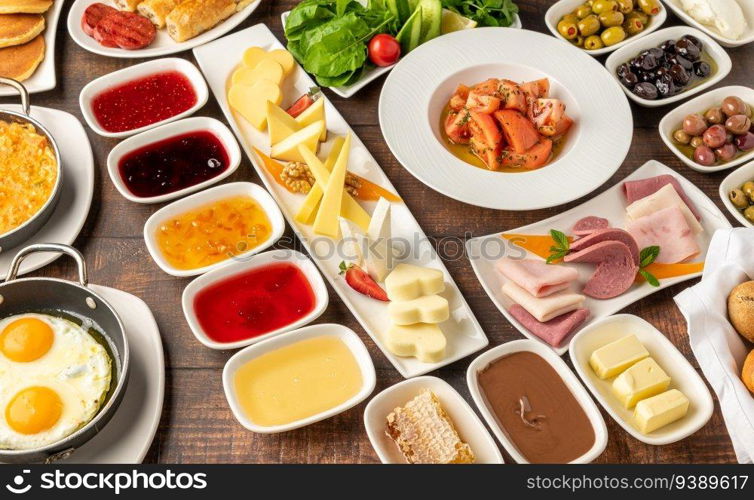 Traditional Turkish Breakfast served with traditional turkish tea on wooden table