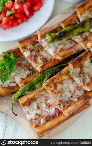 Traditional Turkish cuisine : Pita(pide) with minced meat and cheese.top view.