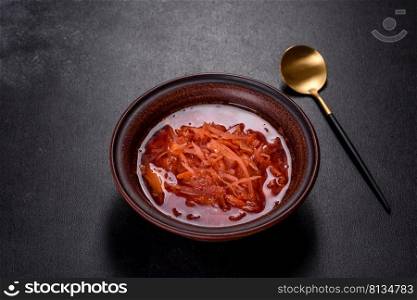 Traditional Ukrainian borscht, bowl of red beet root soup borsch. Traditional Ukrainian borscht with beets, tomatoes, garlic, spices and herbs. Ukrainian dish, traditional food