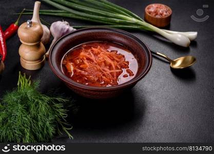 Traditional Ukrainian borscht, bowl of red beet root soup borsch. Traditional Ukrainian borscht with beets, tomatoes, garlic, spices and herbs. Ukrainian dish, traditional food
