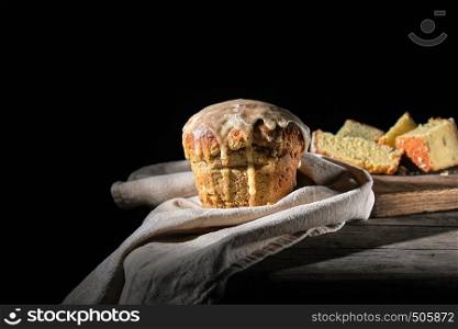 traditional Ukrainian Easter pastry lies on a gray linen towel, black background
