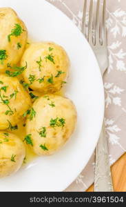 Traditional Ukrainian food boiled new potatoes with butter and dill. Traditional Ukrainian food boiled new potatoes with butter and dill on wooden table