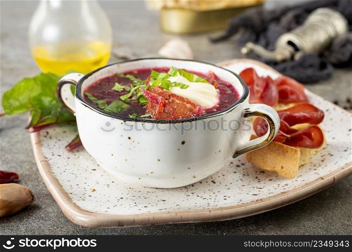 Traditional Ukrainian Russian borscht . Bowl of red beet root soup borsch with white cream . Beet Root delicious soup . Traditional Ukraine food cuisine