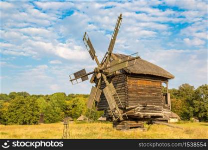 Traditional ukrainian windmill in the museum of national architecture in Pirogovo in a beautiful summer day, Kiev, Ukraine