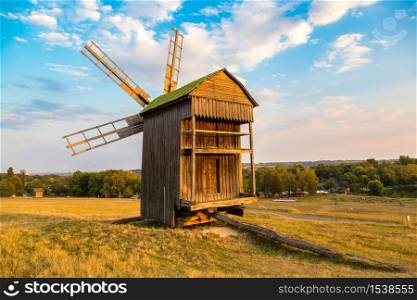 Traditional ukrainian windmill in the museum of national architecture in Pirogovo in a beautiful summer day, Kiev, Ukraine