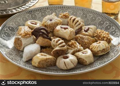 Traditional variety of festive Moroccan cookies and mint tea