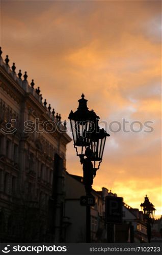 Traditional vintage street lamp and architecture of Prague in the evening