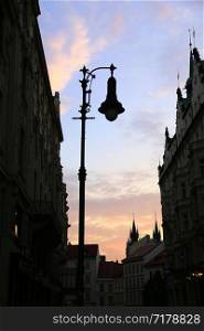 Traditional vintage street lamp and architecture of Prague in the evening