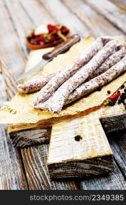 Traditional white salami sausage, sliced salami isolated on white background. Whole dry salami sausage stick.