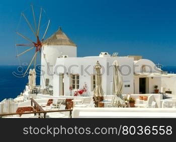 Traditional white windmill in the village Oia. Santorini. Greece.. Windmill in Oia village.