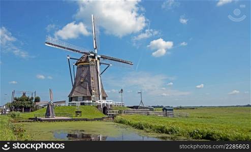 Traditional windmill in a dutch landscape in the Netherlands