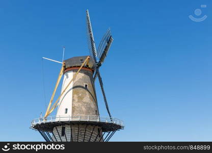 Traditional windmill Oranjemolen at dike near Vlissingen, The Netherlands. Dutch traditional windmill Oranjemolen at dike near Vlissingen