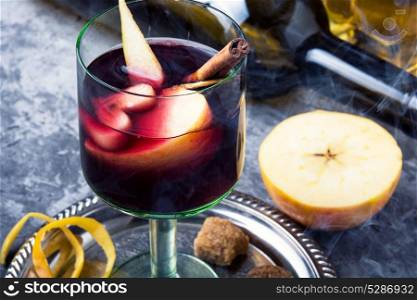 Traditional winter alcohol drink. red mulled wine with apple and spices