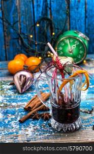 traditional winter cocktail of mulled wine. glass of mulled wine on the background of Christmas decorations.Selective focus