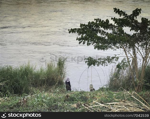 Traditional women fisherman beside the river, stock photo