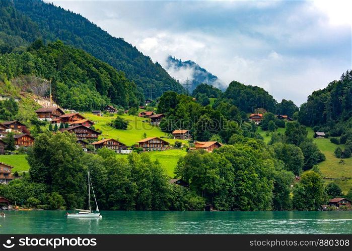 Traditional wood and modern houses along the Lake Brienz in swiss village Iseltwald, Switzerland. Swiss village Iseltwald, Switzerland