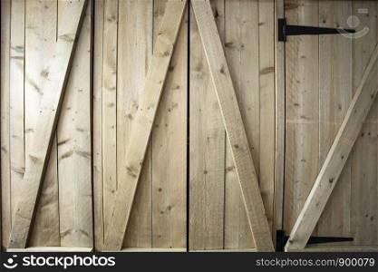 Traditional wooden barn doors detail of farm house doors, close-up clean and modern background textue. Traditional wooden barn doors detail of farm house doors, close-up clean and modern