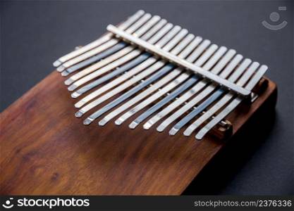 Traditional wooden kalimba isolated on black background. Traditional wooden kalimba isolated on black